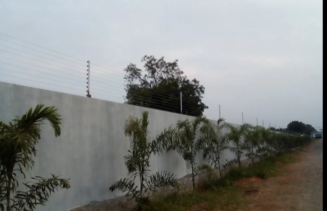 Boundary wall with electric fence wire installation
