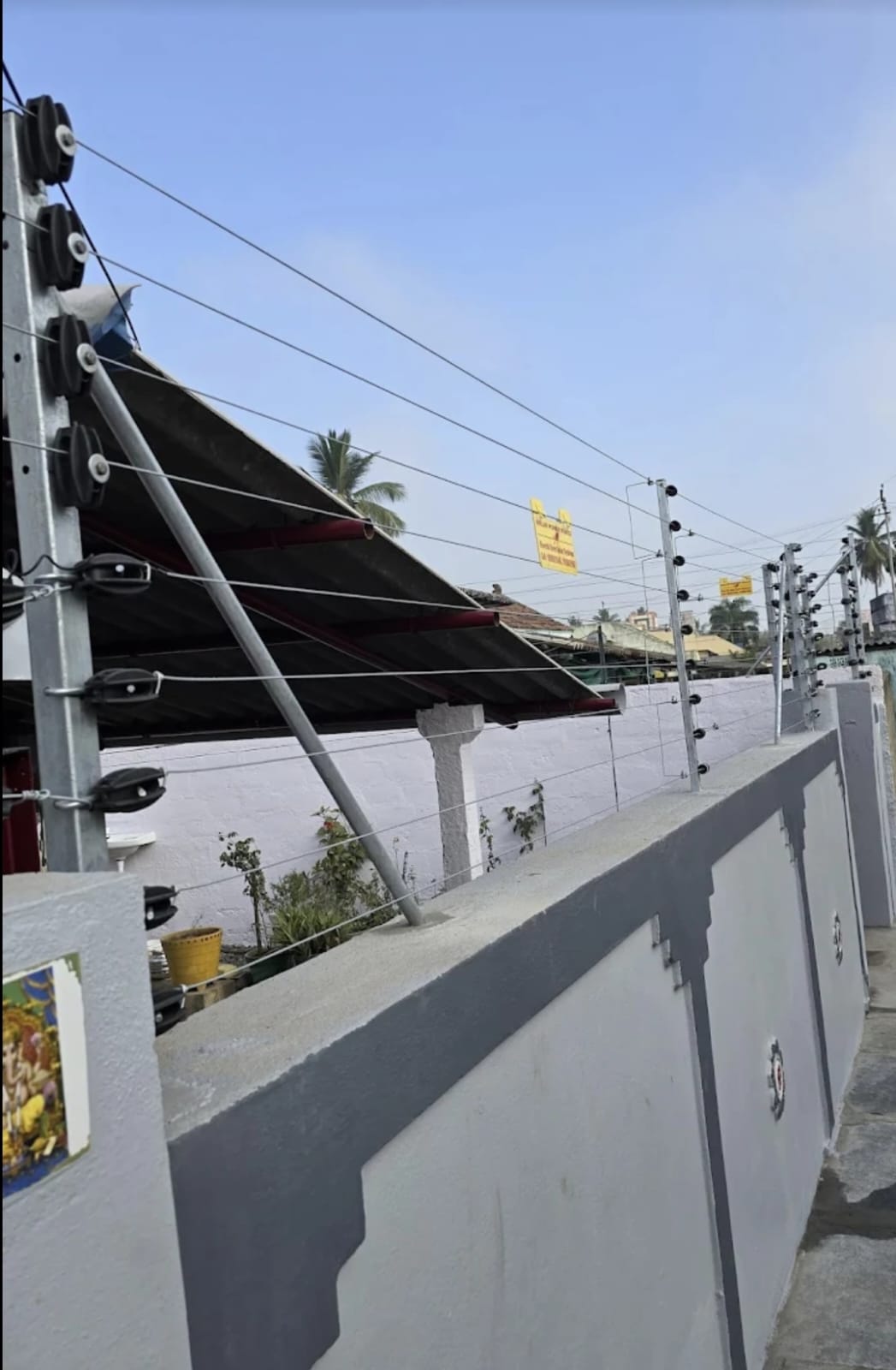 Boundary wall with electric fence installation